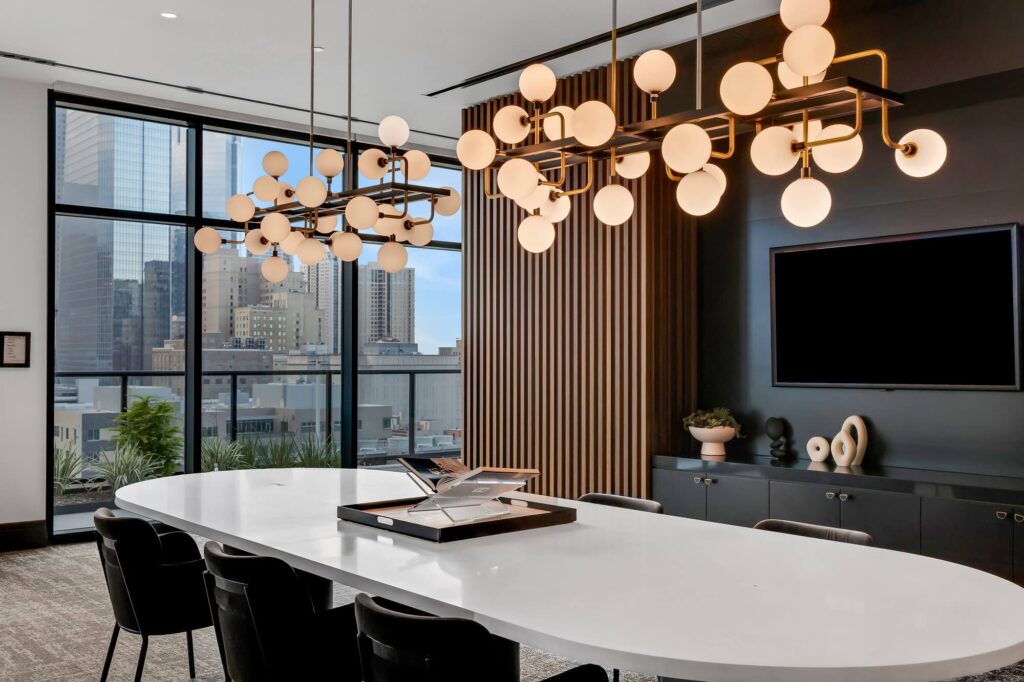 Interior clubhouse with dining table seating and mounted television